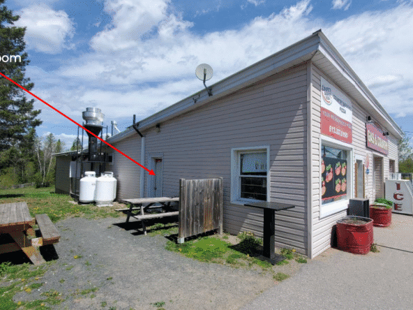 Small gas station convenience store with washroom and outdoor seating in Wollaston, Ontario.