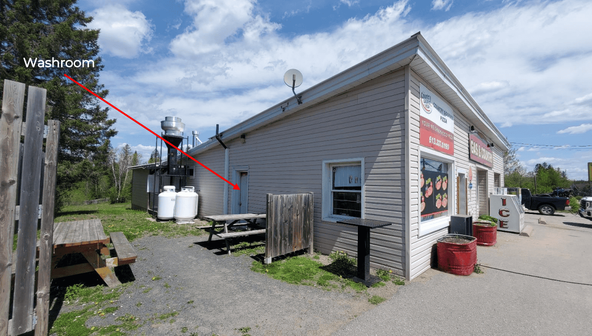 Small gas station convenience store with washroom and outdoor seating in Wollaston, Ontario.